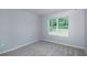 Bedroom with neutral carpeting and window overlooking green space at 327 Larch Rd, Ocala, FL 34480