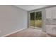 Dining area with sliding glass doors and a kitchen with white cabinets and granite countertops at 327 Larch Rd, Ocala, FL 34480