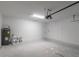 Garage featuring a concrete floor, water heater, and storage space at 327 Larch Rd, Ocala, FL 34480
