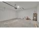 Spacious garage with concrete floors, overhead door and hot water tank at 327 Larch Rd, Ocala, FL 34480