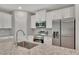 Close-up of the kitchen island with granite countertops, stainless steel appliances, and white cabinets at 327 Larch Rd, Ocala, FL 34480
