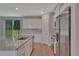 Spacious kitchen with granite countertops, stainless appliances, white cabinetry, and a sliding door to the yard at 327 Larch Rd, Ocala, FL 34480