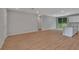 Spacious open concept living area leading to the kitchen, with wood-look floors at 327 Larch Rd, Ocala, FL 34480