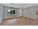 Open living area with wood-look floors, a window, and neutral paint, perfect for entertaining at 327 Larch Rd, Ocala, FL 34480