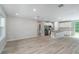 Open-concept living area with wood-look flooring seamlessly flowing into the kitchen space at 327 Larch Rd, Ocala, FL 34480
