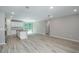 Large living space showcasing wood-look floors and an island separating the living area from the kitchen at 327 Larch Rd, Ocala, FL 34480