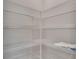 Walk-in pantry features white wire shelving and ample storage space for kitchen supplies and food at 327 Larch Rd, Ocala, FL 34480