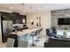Open-concept kitchen featuring stainless steel appliances, gray cabinetry, and a long island with bar seating at 456 Ocean Course Ave, Davenport, FL 33896