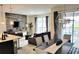 Open-concept living space with modern decor, adjacent to a dining area and access to a patio and pool at 456 Ocean Course Ave, Davenport, FL 33896