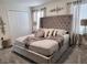 Comfortable bedroom featuring a luxurious upholstered bed, plush bedding, and stylish decor elements at 456 Ocean Course Ave, Davenport, FL 33896