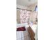 Modest bathroom with a tub and shower and vanity with pink accents and a floral shower curtain at 4719 Miranda Cir, Orlando, FL 32818