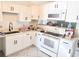 Bright kitchen with white cabinets, modern sink fixture, and appliances at 4719 Miranda Cir, Orlando, FL 32818