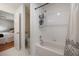 Clean bathroom offering a tiled shower-tub, white tile floor, and a view into the bedroom at 478 N Sundance Dr, Lake Mary, FL 32746