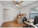 Sun-filled bedroom offers wood floors, a ceiling fan, and an abundance of natural light at 478 N Sundance Dr, Lake Mary, FL 32746