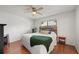 Cozy bedroom with hardwood floors, a ceiling fan, and a window bringing in natural light at 478 N Sundance Dr, Lake Mary, FL 32746
