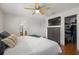 A bedroom featuring warm hardwood floors, ceiling fan, large dresser and walk-in closet at 478 N Sundance Dr, Lake Mary, FL 32746