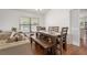 Dining area featuring a wood table with bench seating and an adjacent living room with neutral decor at 478 N Sundance Dr, Lake Mary, FL 32746