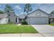 Charming single-story home with a well-maintained lawn, stone accents, and an attached two-car garage at 478 N Sundance Dr, Lake Mary, FL 32746