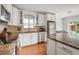 Kitchen with white cabinets, stainless steel appliances, granite counter tops and access to backyard at 478 N Sundance Dr, Lake Mary, FL 32746