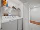 Functional laundry room features a washer, dryer, and ample storage space for cleaning supplies at 478 N Sundance Dr, Lake Mary, FL 32746