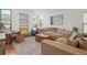 Bright living room with large windows, neutral decor, comfortable seating, and built-in shelving at 478 N Sundance Dr, Lake Mary, FL 32746