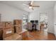 Open-concept living space boasts wood floors and a ceiling fan, flooded with natural light at 478 N Sundance Dr, Lake Mary, FL 32746