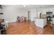 An open-plan living space with hardwood floors and a modern kitchen featuring white cabinets and granite counters at 478 N Sundance Dr, Lake Mary, FL 32746