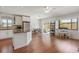 Open-concept living space with kitchen and a patio view, featuring warm hardwood floors and natural lighting at 478 N Sundance Dr, Lake Mary, FL 32746