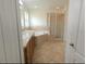 Bathroom with double vanity, tub, and glass shower at 4852 Magnolia Preserve Dr, Winter Haven, FL 33880