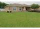 Lovely home showcasing a lush green lawn, clean architectural lines and well-placed landscaping at 4852 Magnolia Preserve Dr, Winter Haven, FL 33880