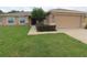 Charming home featuring a well-maintained lawn and a two-car garage with stone-accented columns at 4852 Magnolia Preserve Dr, Winter Haven, FL 33880