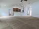 Open concept living room with view of kitchen bar and dark cabinets at 4852 Magnolia Preserve Dr, Winter Haven, FL 33880