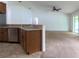 Bright living area with a breakfast bar, ceiling fan, and sliding glass doors to lanai at 4852 Magnolia Preserve Dr, Winter Haven, FL 33880