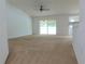 Expansive living room with carpet flooring and sliding doors, offering plenty of natural light at 4852 Magnolia Preserve Dr, Winter Haven, FL 33880