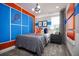 Unique bedroom with a tennis-themed accent wall, modern furnishings and decor at 5328 Teirgarten St, St Cloud, FL 34771