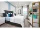 Cozy bedroom featuring blue accents, plush bedding, and ample natural light creating a serene atmosphere at 5328 Teirgarten St, St Cloud, FL 34771