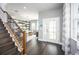 Inviting foyer features hardwood floors, staircase, and an open view of the dining area at 5328 Teirgarten St, St Cloud, FL 34771