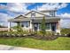 Charming home exterior featuring manicured landscaping, covered entry, and architectural details at 5328 Teirgarten St, St Cloud, FL 34771