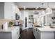 Well-lit kitchen with an island, sleek appliances, quartz countertops, and ample cabinet space at 5328 Teirgarten St, St Cloud, FL 34771
