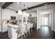 Beautiful kitchen with hardwood floors, island with seating, stainless steel appliances, and white cabinets at 5328 Teirgarten St, St Cloud, FL 34771