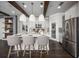 Stunning kitchen showcasing hardwood floors, island seating, stainless steel appliances, and modern lighting at 5328 Teirgarten St, St Cloud, FL 34771