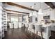 Open kitchen with dark hardwood floors, large island, modern pendant lights, and white cabinetry at 5328 Teirgarten St, St Cloud, FL 34771