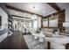 Open-concept living space with hardwood floors, decorative ceiling beams, stylish furnishings and abundant natural light at 5328 Teirgarten St, St Cloud, FL 34771