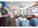 Inviting living room with stylish furniture, graffiti wall art, and game table for Gathering fun and relaxation at 5328 Teirgarten St, St Cloud, FL 34771