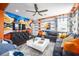 Comfortable living room featuring modern design, a large sectional sofa, and gaming accessories, perfect for recreation at 5328 Teirgarten St, St Cloud, FL 34771