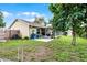 Large backyard featuring mature tree, a lawn, and a screened-in patio area, with room for entertaining at 5815 England Ave, Orlando, FL 32808