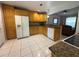 Bright kitchen with wooden cabinets, granite countertops, and white appliances at 5815 England Ave, Orlando, FL 32808
