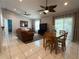 Open-concept living area featuring tile flooring, ceiling fans, and ample natural light at 5815 England Ave, Orlando, FL 32808
