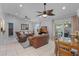 Spacious living room with two ceiling fans, tile flooring, and sliding door to the patio at 5815 England Ave, Orlando, FL 32808
