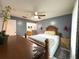 Spacious main bedroom showcasing gray walls, a ceiling fan, and a view into the en-suite bathroom at 5815 England Ave, Orlando, FL 32808